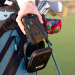 Golfer reaching for Tour V6 Shift Laser Rangefinder Black Variant from carry case attached to golf bag